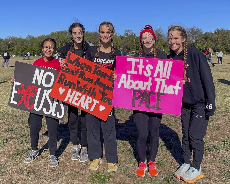 XC girls with spirit signs