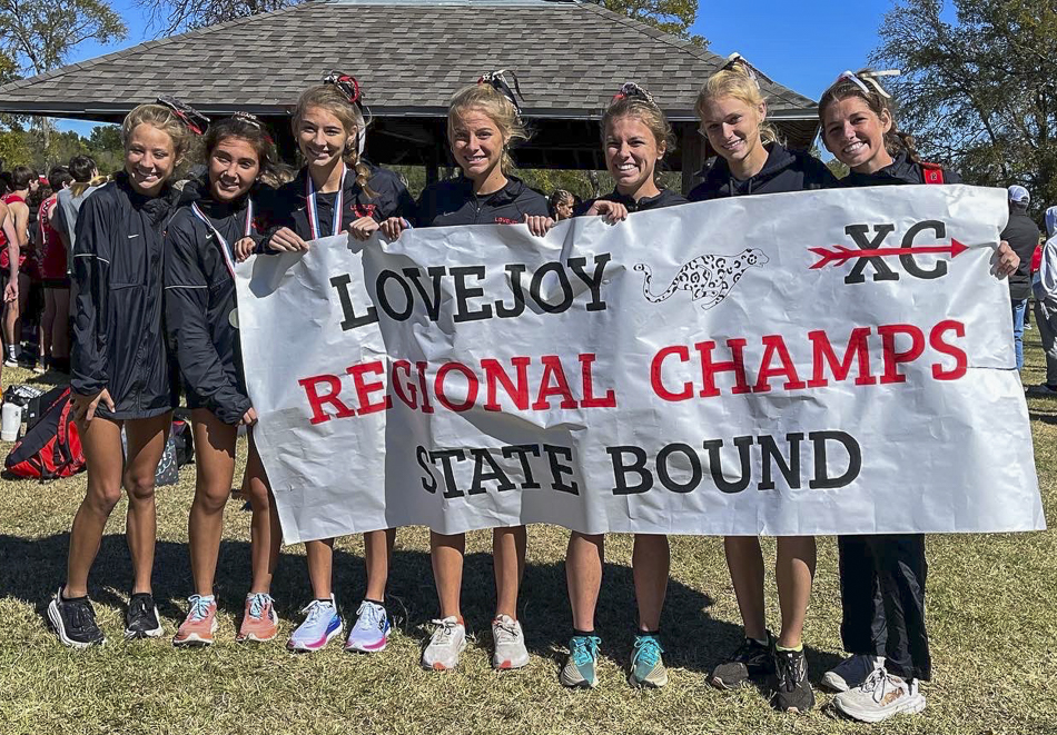 Varsity girls with spirit sign