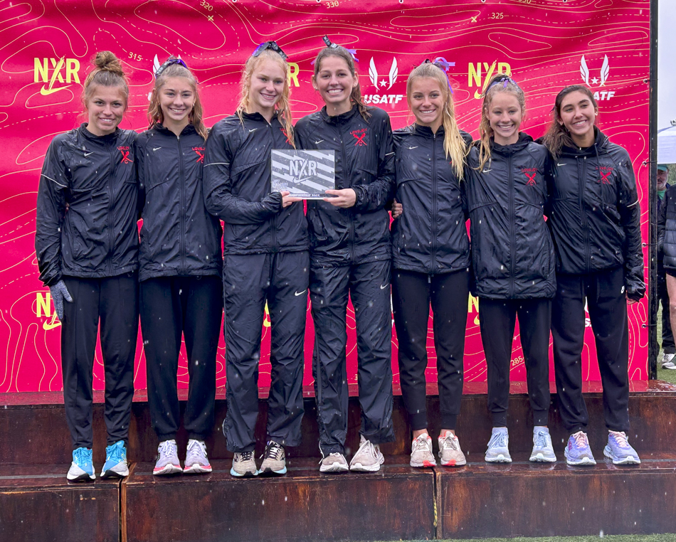 the Varsity girls on the podium with their 2nd place plaque