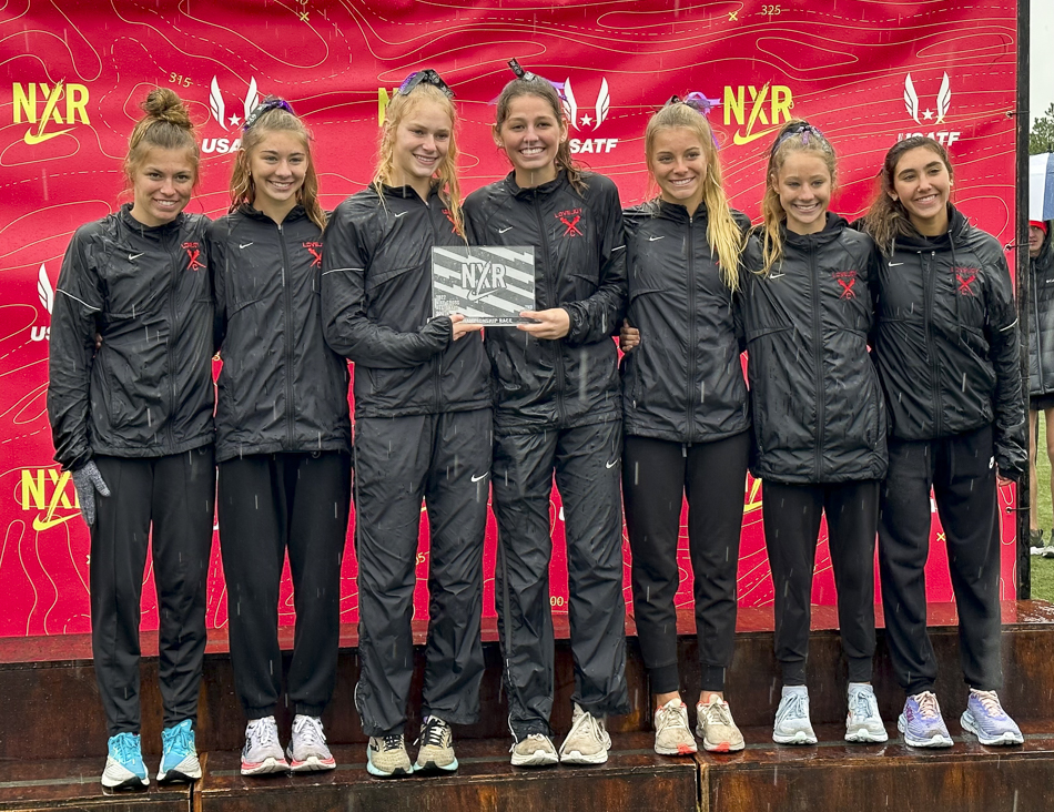 the Varsity girls on the podium with their 2nd place plaque